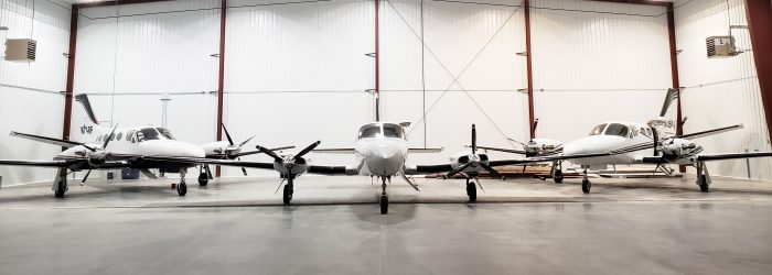 three airplanes in hangar