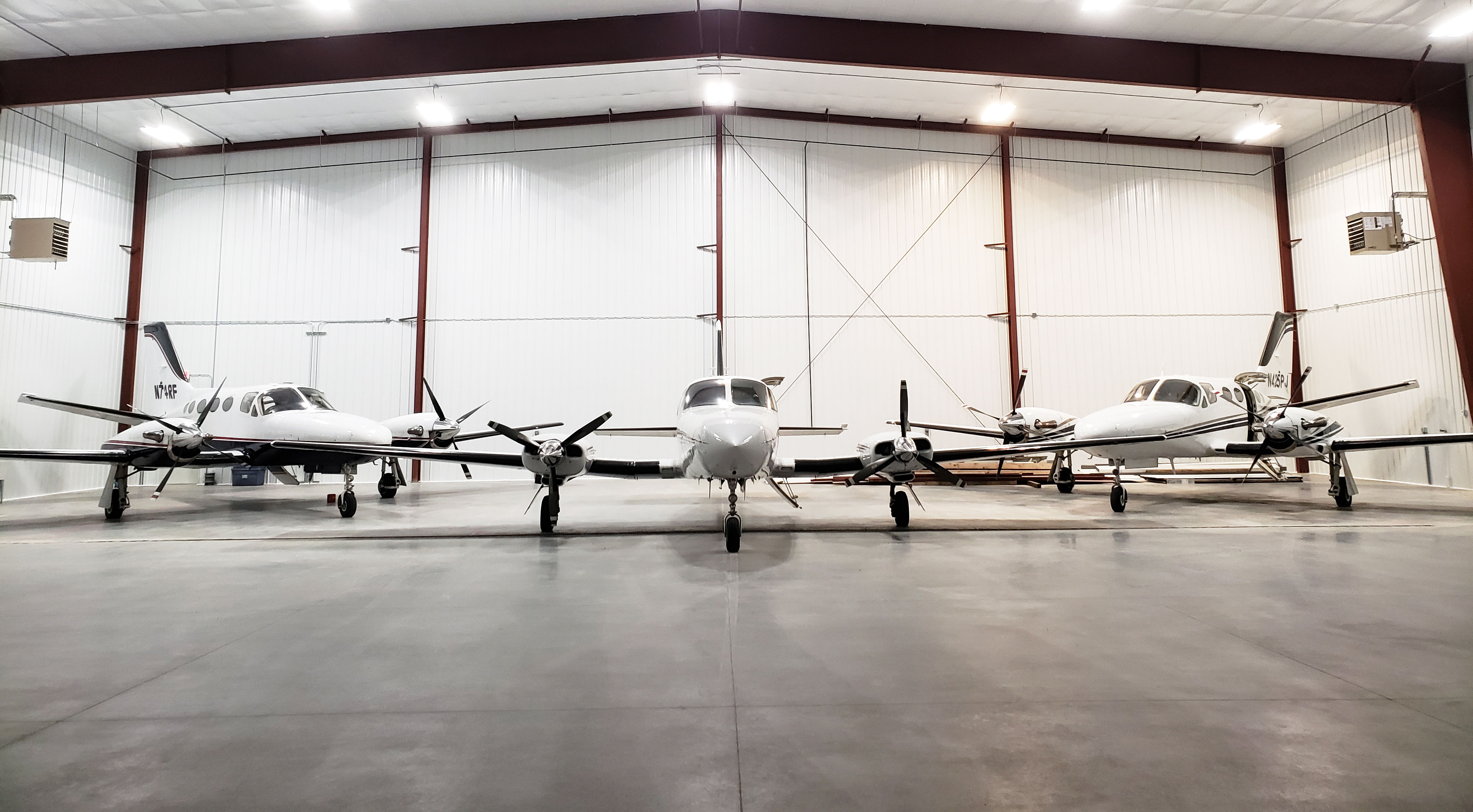 three airplanes in hangar